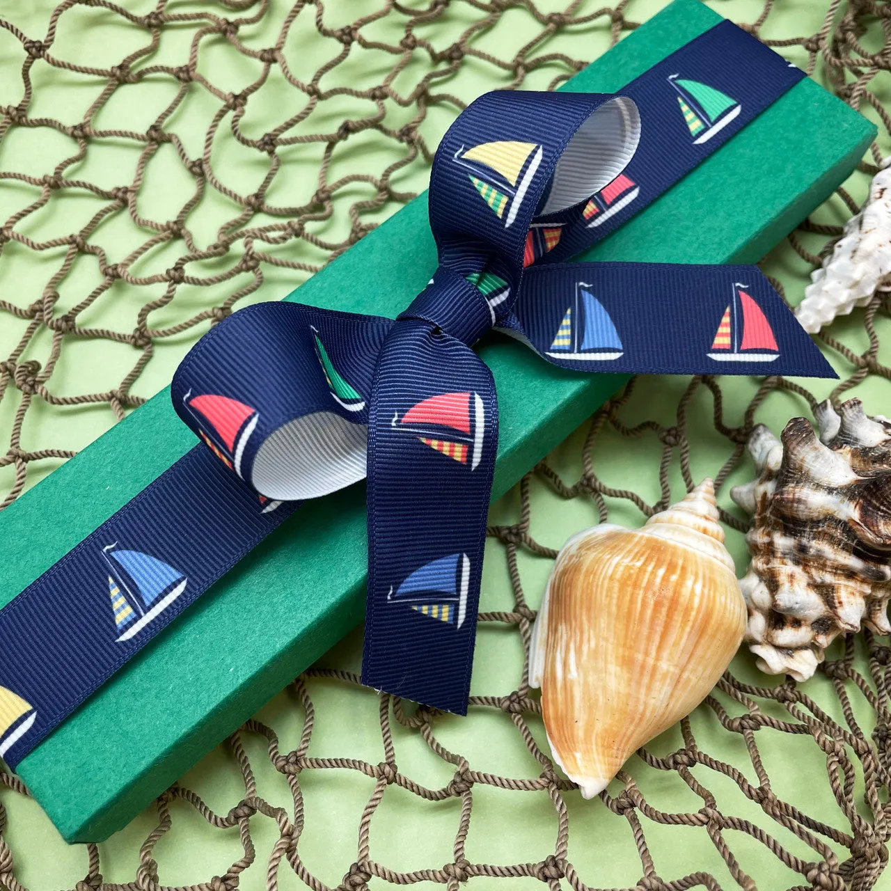 Sailboat ribbon Sailboats with green, yellow, blue and red sails on a navy background printed on 7/8" white satin and grosgrain